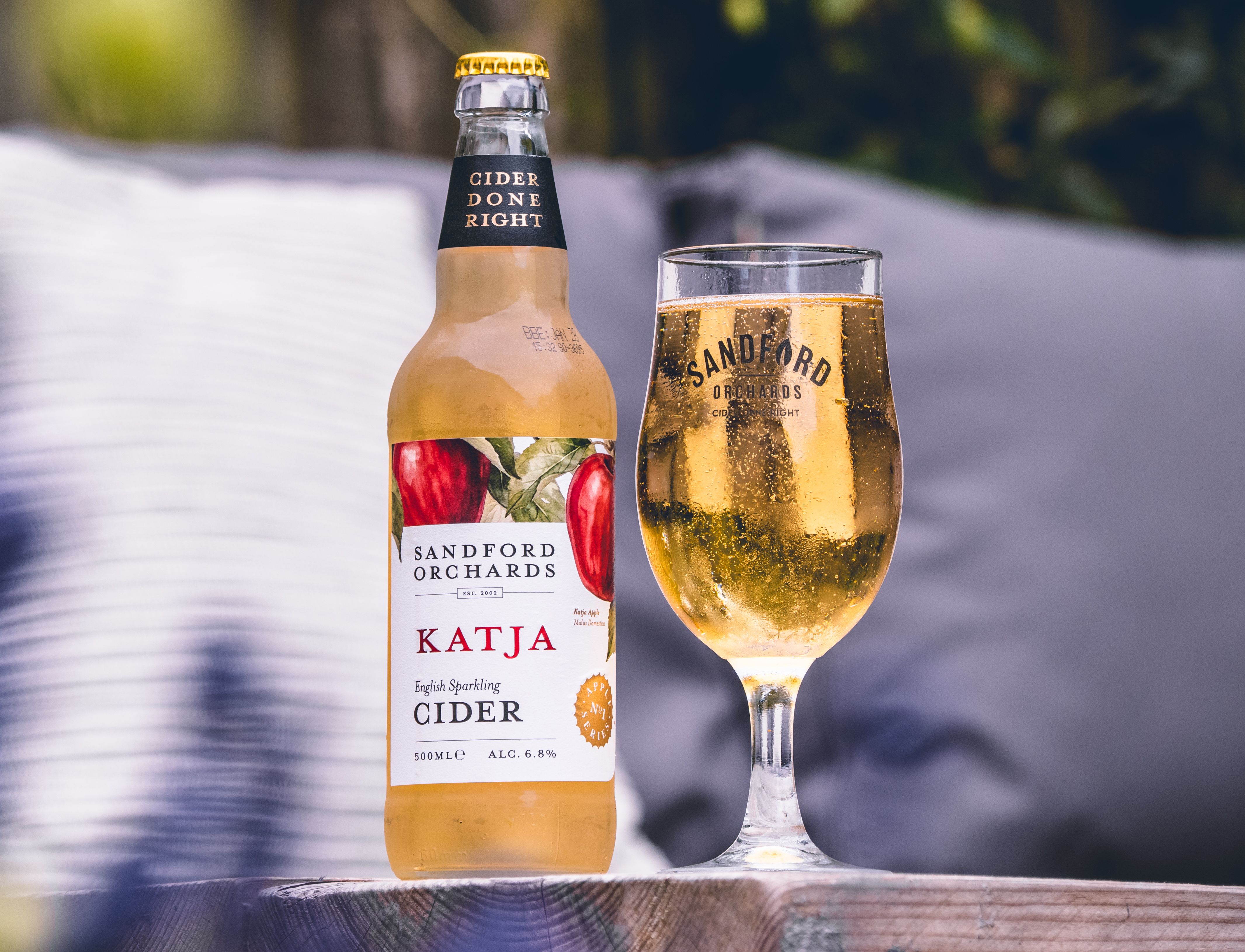 Sandford Orchards Katja sparkling cider - a 500ml bottle next to a glass full of cider