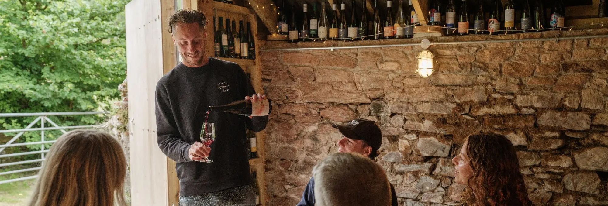 Sandridge Barton Guided Tasting Tom pouring wine with a small group
