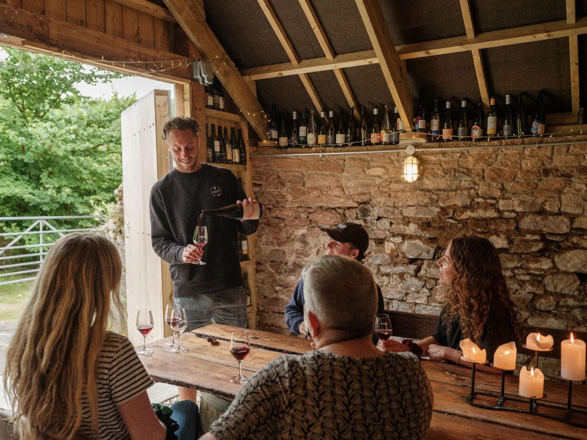 Sandridge Barton Guided Tasting Tom pouring wine with a small group
