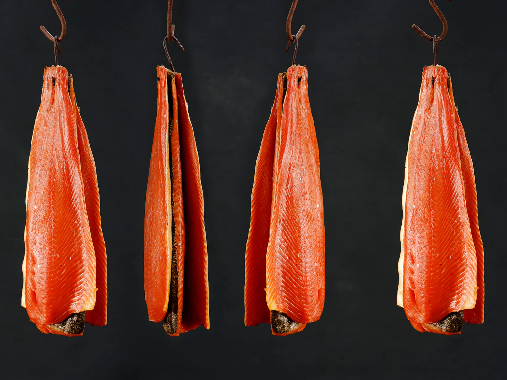 Blakewell sides of Smoked Salmon hanging from hooks