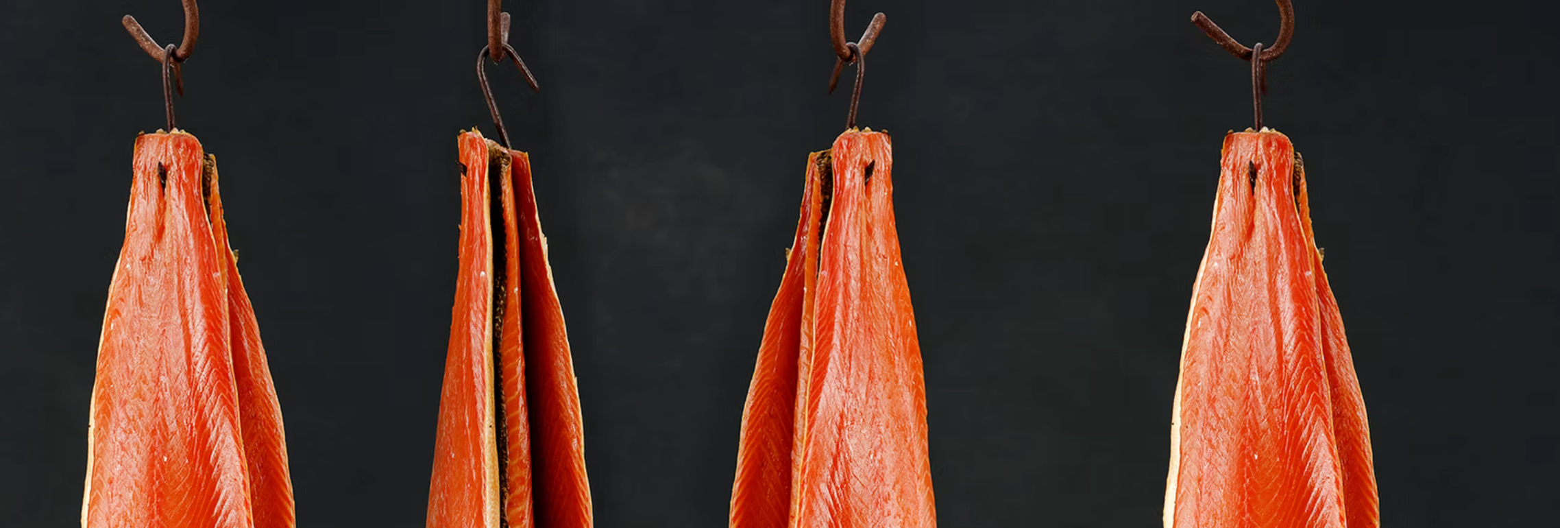 Blakewell sides of Smoked Salmon hanging from hooks