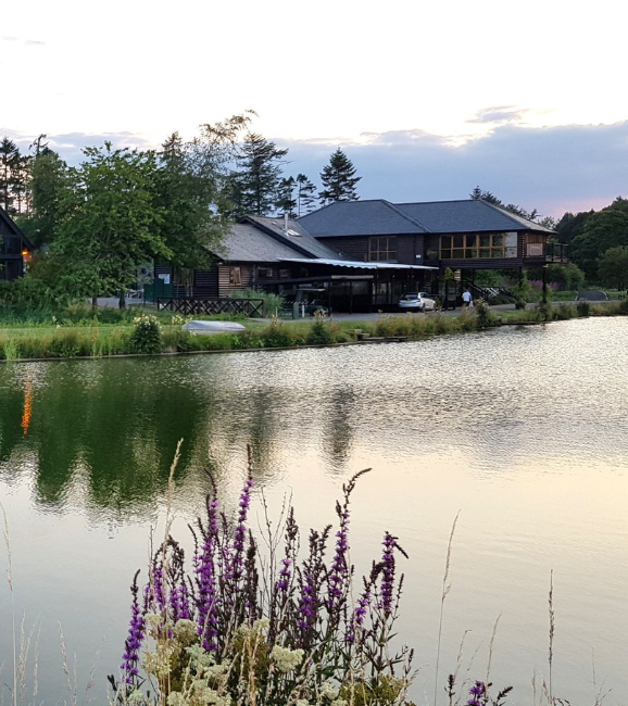 The main resort buildings mirrored in the still water.