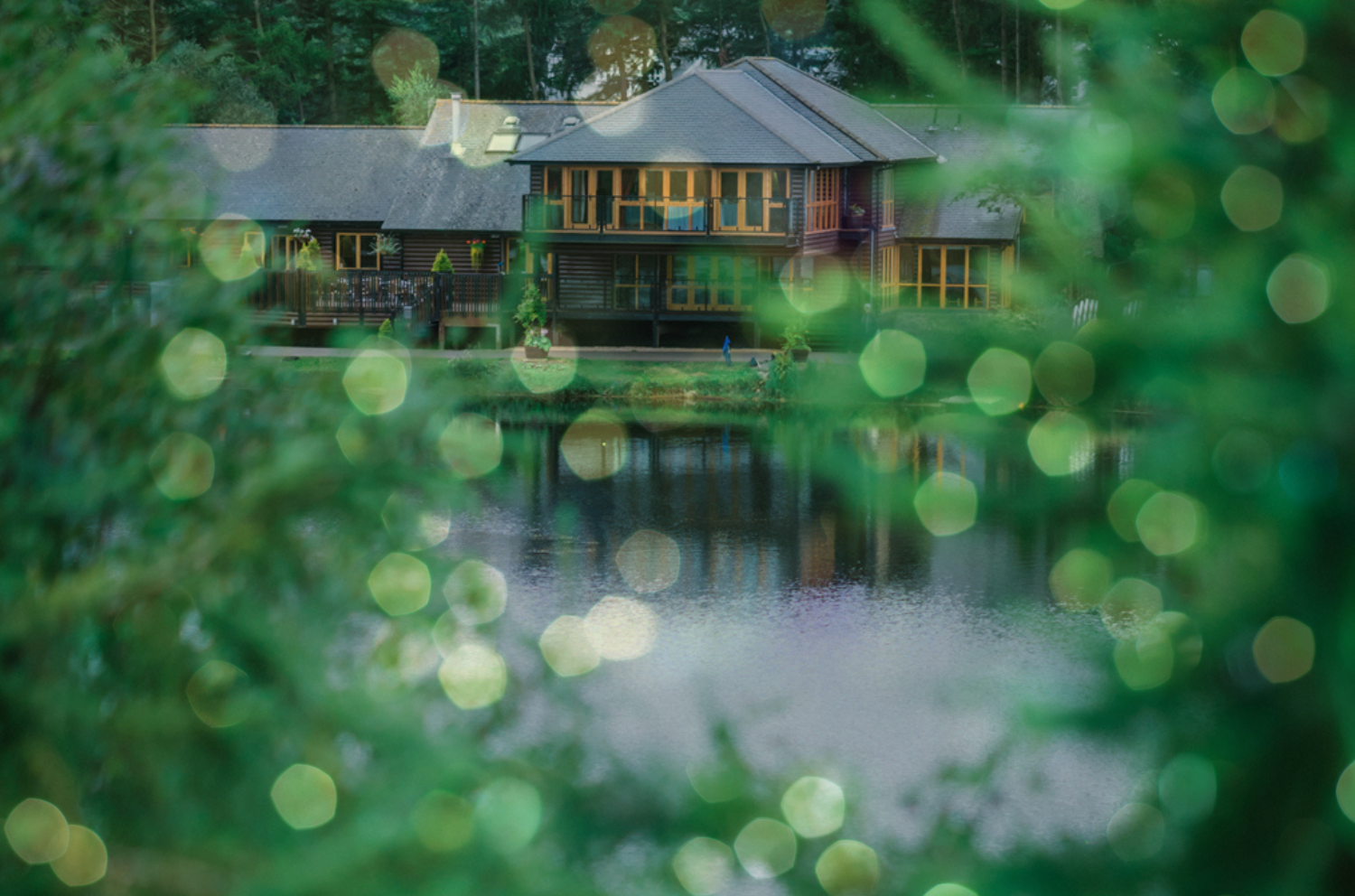A view of the main resort building overlooking the water with sparkling lights