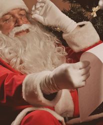 Santa Claus reading over the Good List.