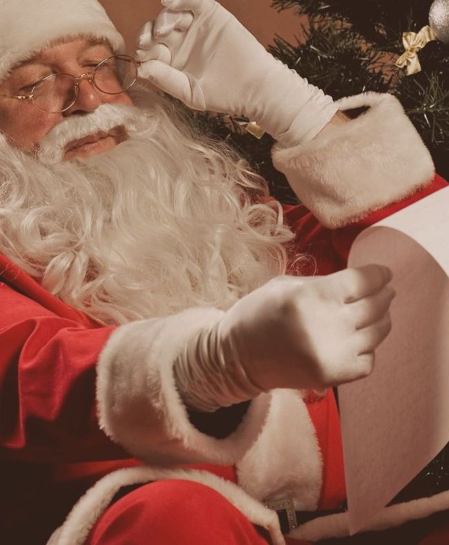 Santa Claus reading over the Good List.