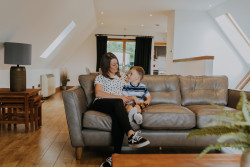 Woman and child sat on sofa