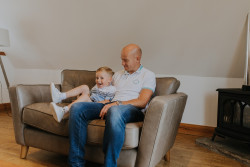 Man and child on sofa