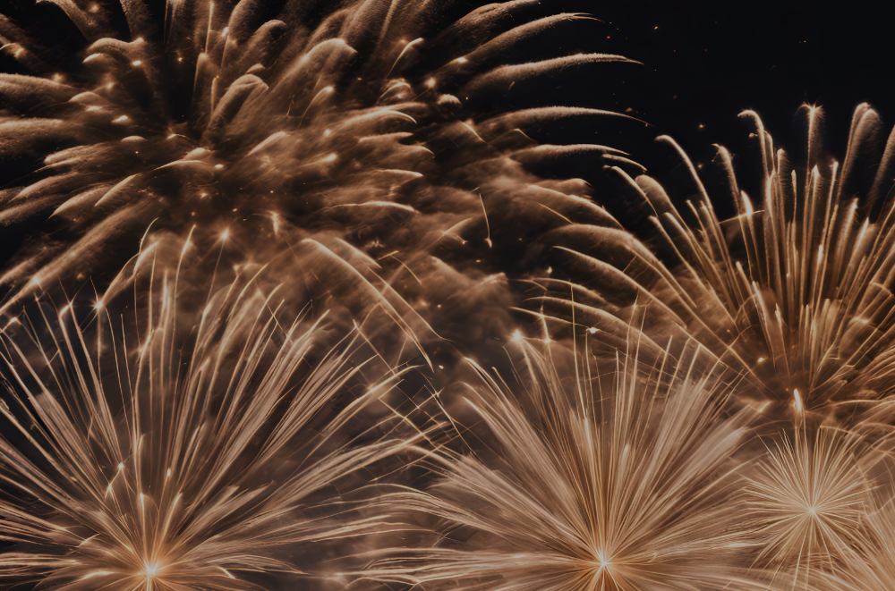 Golden fireworks bursting in the night sky