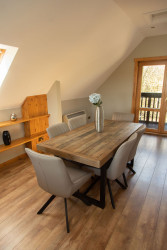 Dining table with vase of flowers