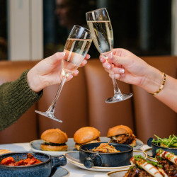 People with champagne and selection of dishes