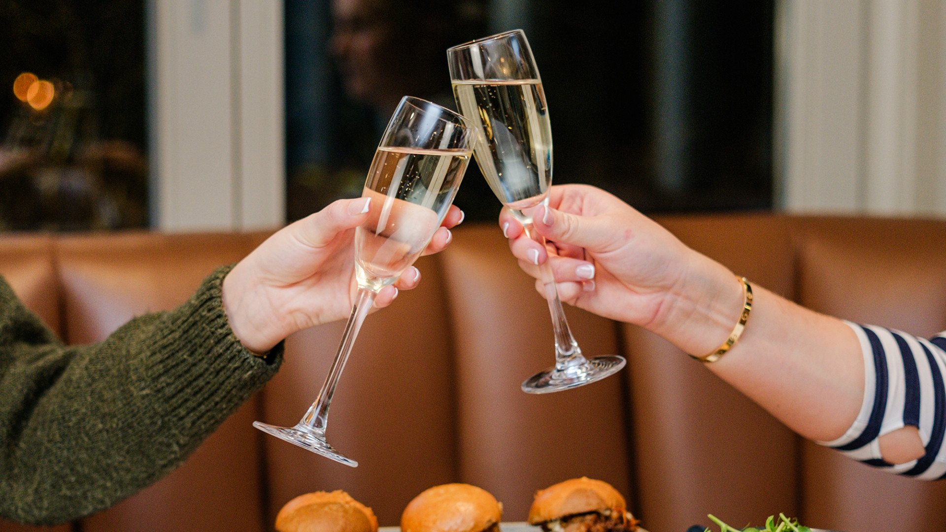 People with champagne and selection of dishes