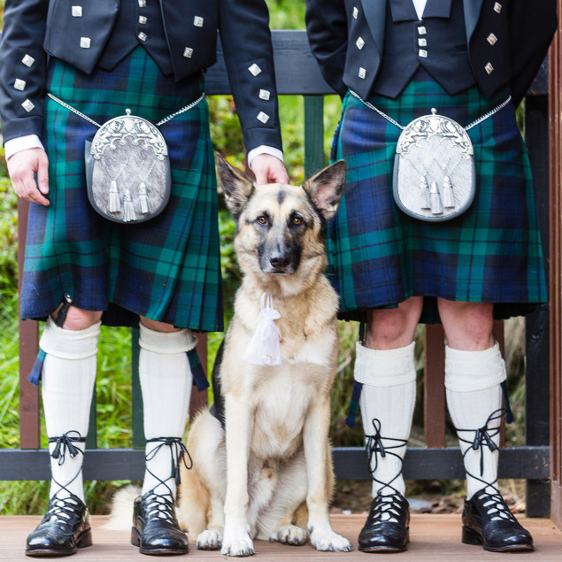 2 men in kilts with dog