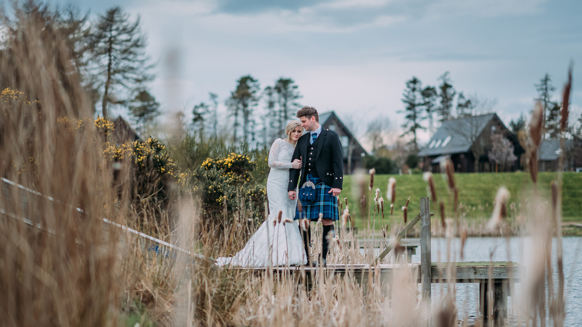 Bride and groom by fishing pond