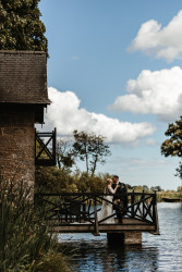 Bride and groom on boathouse balcony