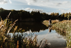 Bride and groom by fishing pond