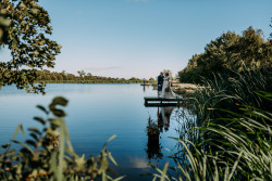 Bride and groom by fishing pond