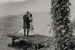 Bride and groom by fishing pond