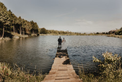 Bride and groom by fishing pond