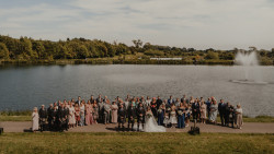Wedding group photo by fishing pond
