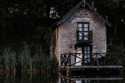 Bride and groom on boathouse balcony
