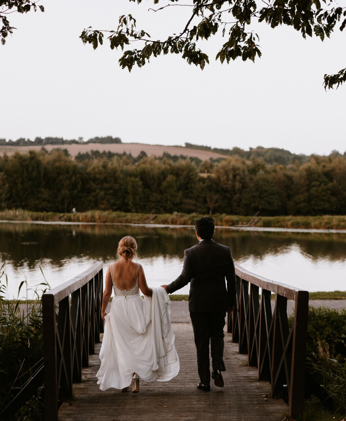 Bride and groom by fishing pond