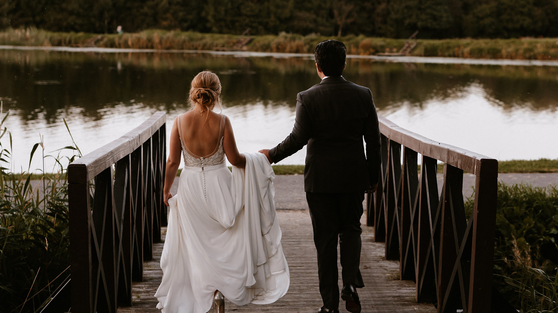 Bride and groom by fishing pond