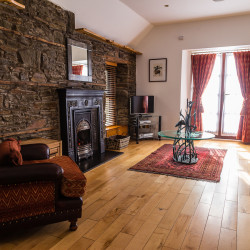 Armchair and fireplace in boathouse living room
