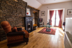 Armchair and fireplace in boathouse living room