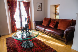 Glass table and sofa in boathouse living room