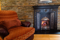 Armchair and fireplace in boathouse living room