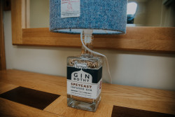 Harris tweed lamp with gin bottle base
