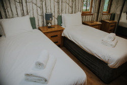 Twin beds in Glen Lyon lodge