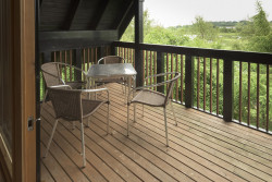 Table and chairs on balcony of Glen Lyon lodge