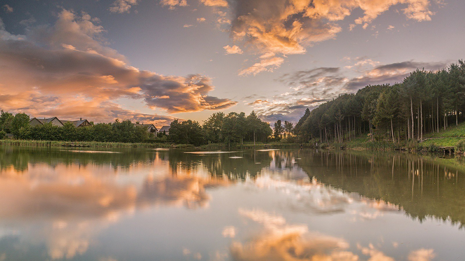 Sunset sky reflecting in fishing pond