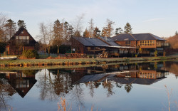 Restaurant and lodges reflection in fishing pond