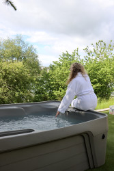 Woman sat on edge of hot tub