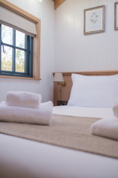 Towels on bed in shepherds hut