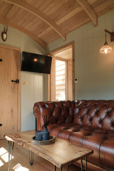 Sofa in sitting area in shepherds hut