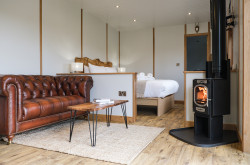Seating area with log burner in The Burrow