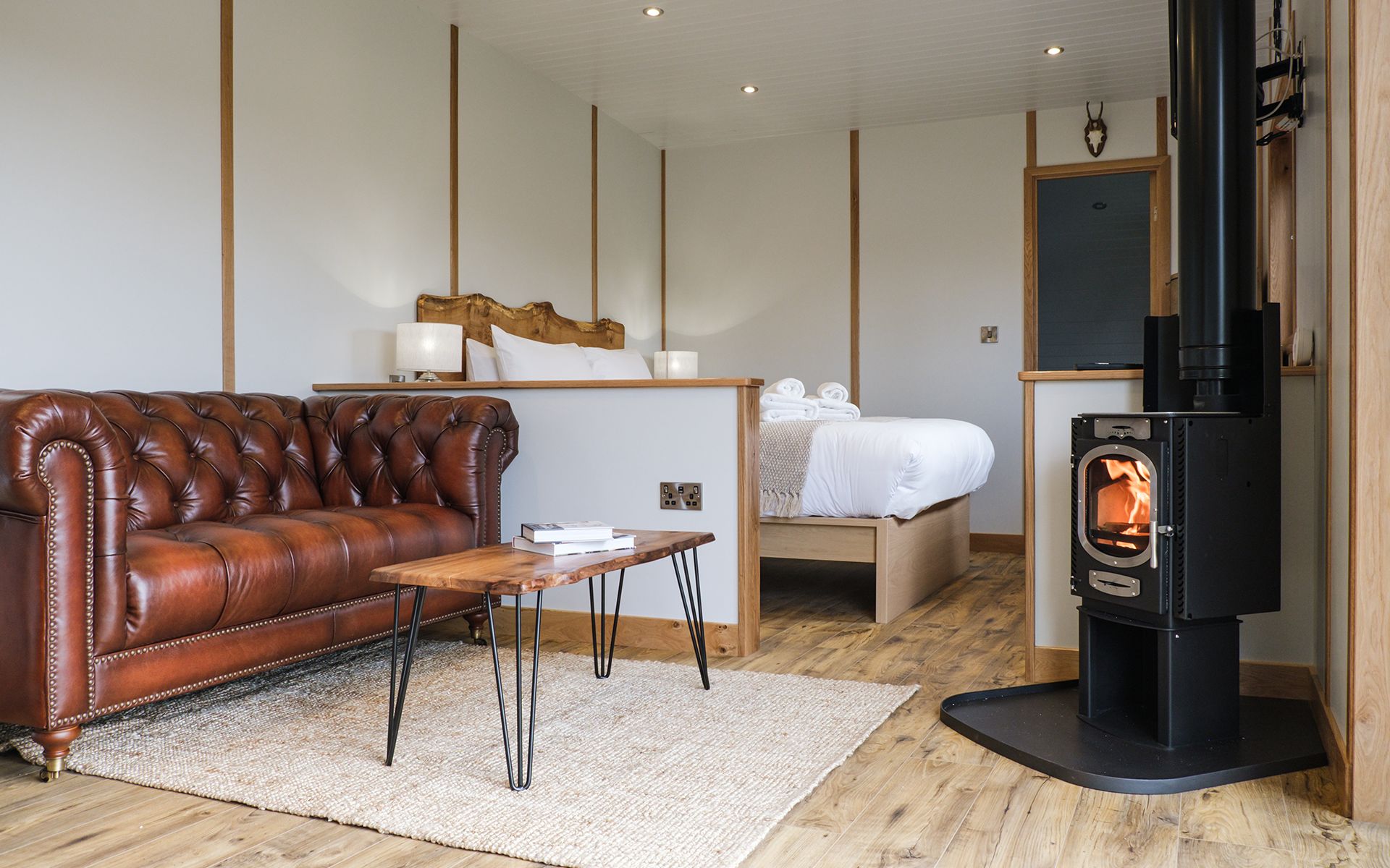 Seating area with log burner in The Burrow