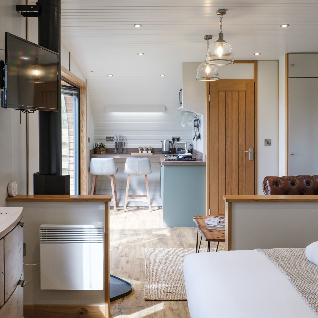 Seating area with log burner in The Burrow
