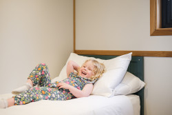 Child on bed in The Burrow