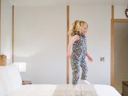 Child jumping on bed