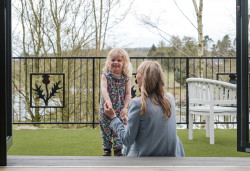 Child and adult outside Bankside Bothy