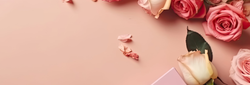 Valentine's Day text with pink and cream roses, rose petals, chocolate box, and a pink gift box on a soft pink background.