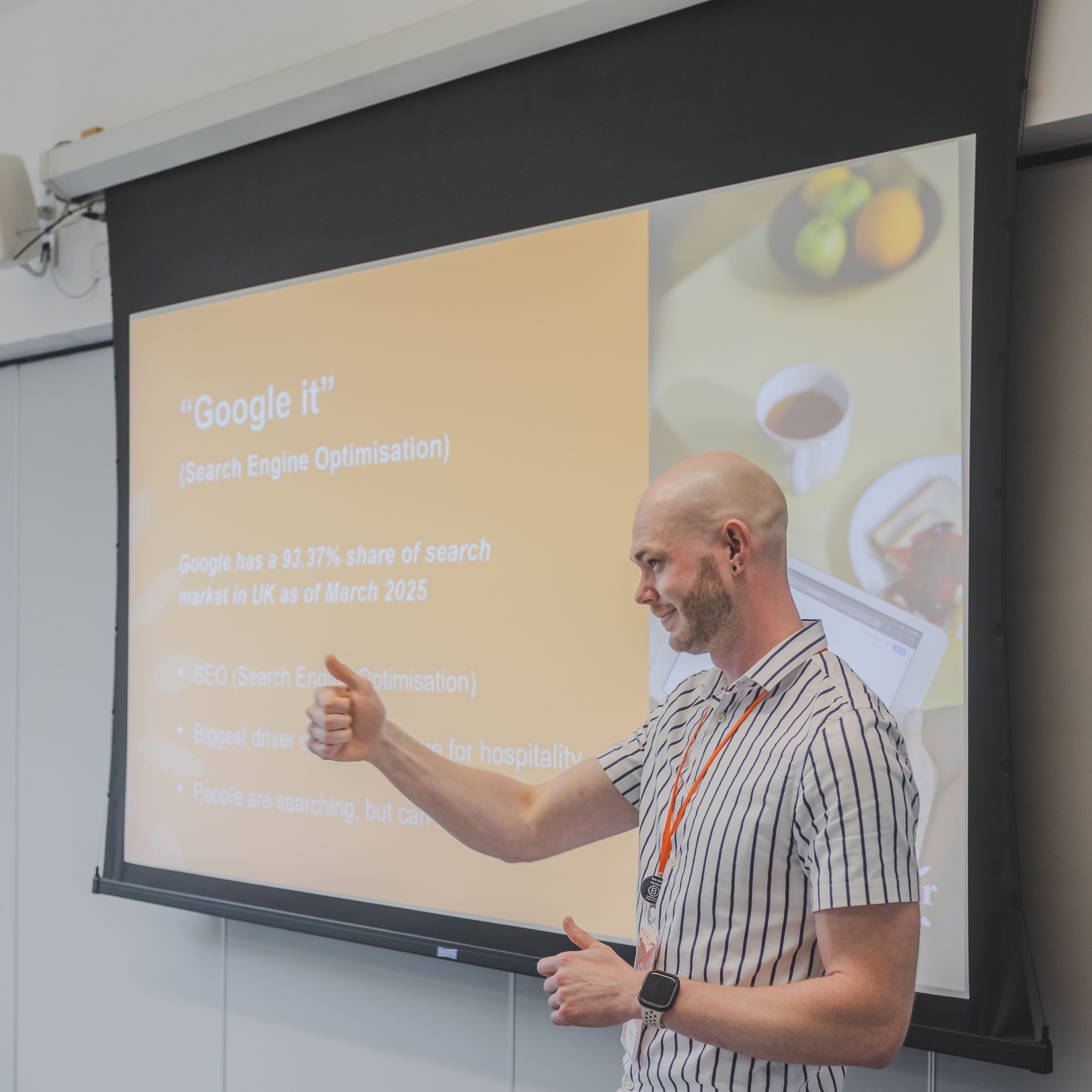 Person giving a presentation about search engine optimisation in front of a projector screen