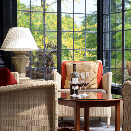 Glasses of wine on table by window