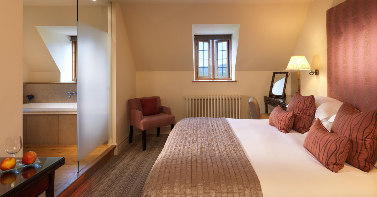 Bedroom with chair, bed lamp and mirror