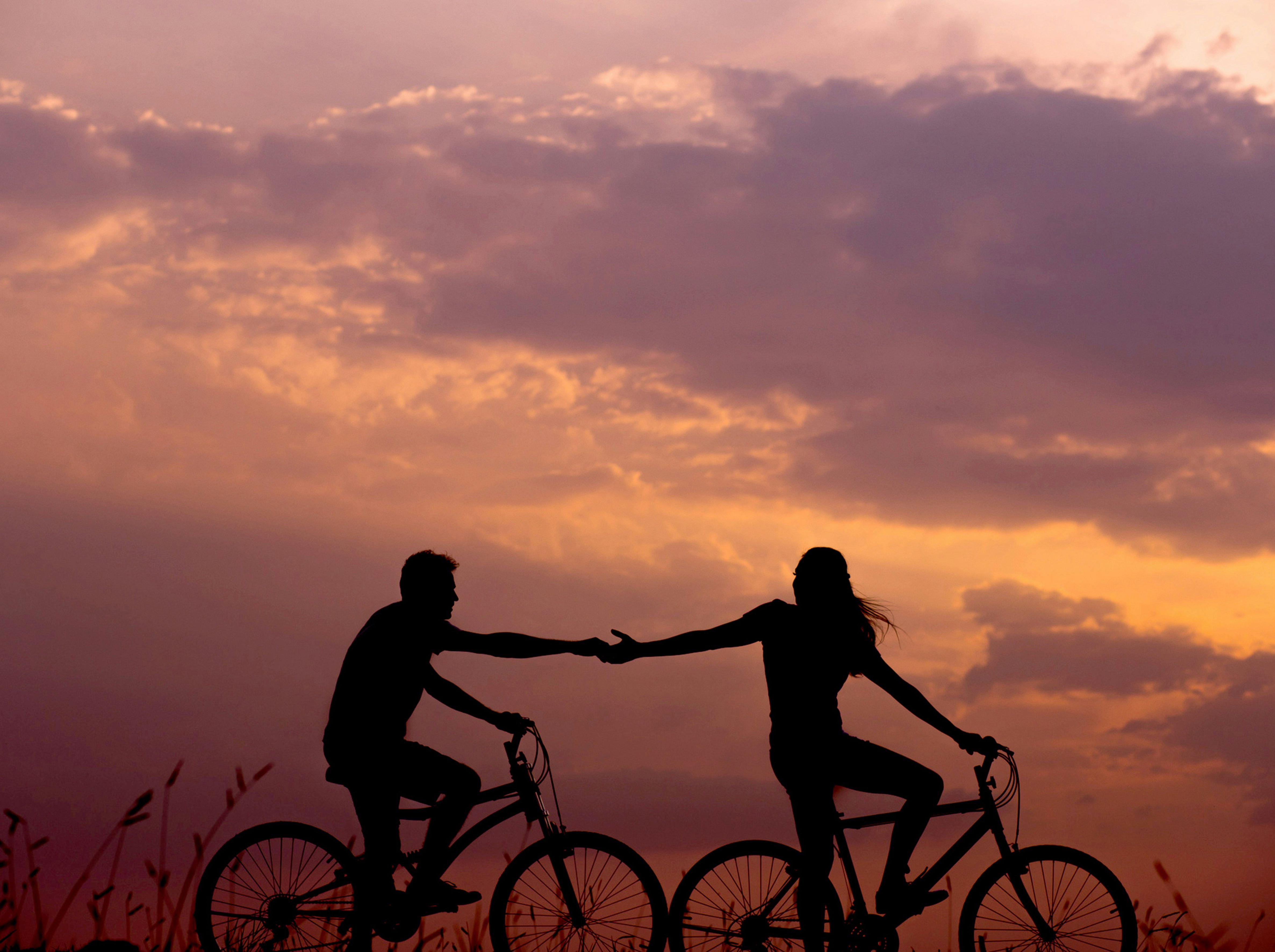 Couple on bicycles at sunset