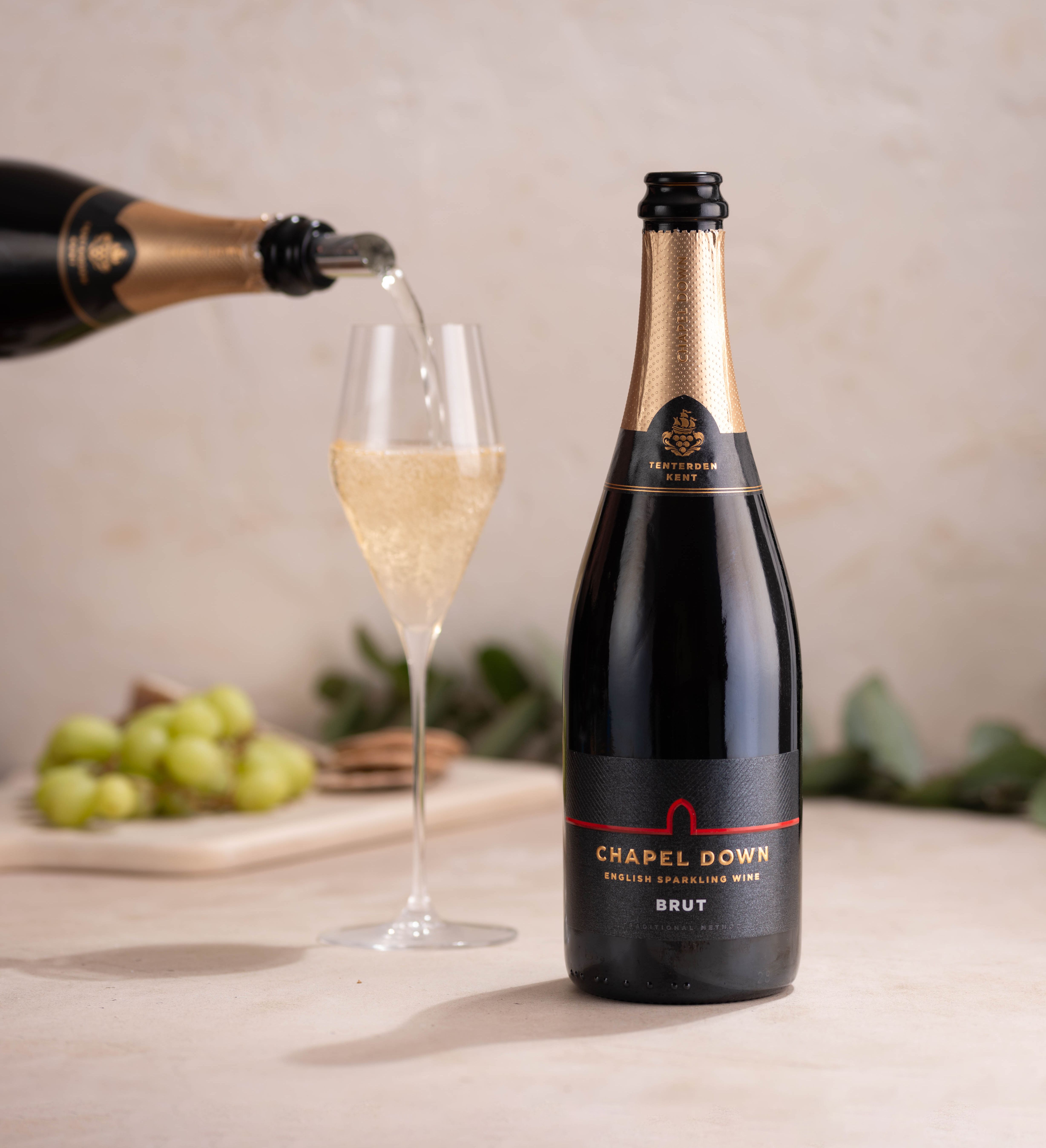 Chapel Down Brut English Sparkling Wine bottle with a glass being poured